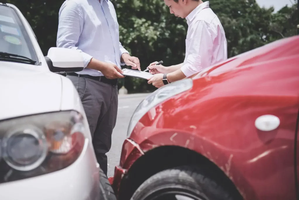 insurance-agent-examine-damaged-car-and-customer